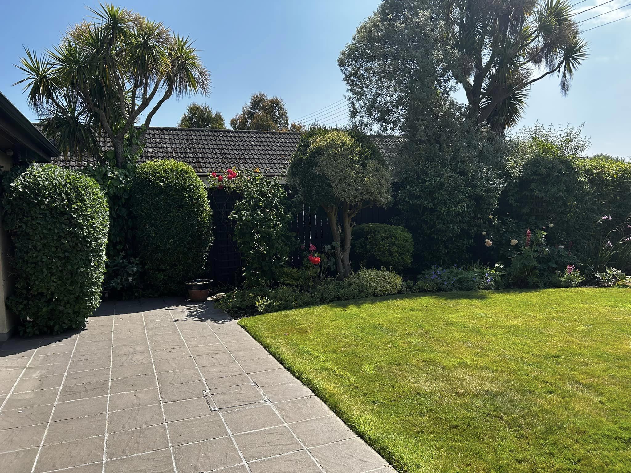 Patio with grass in back garden